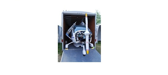 Small airplane inside an enclosed trailer
